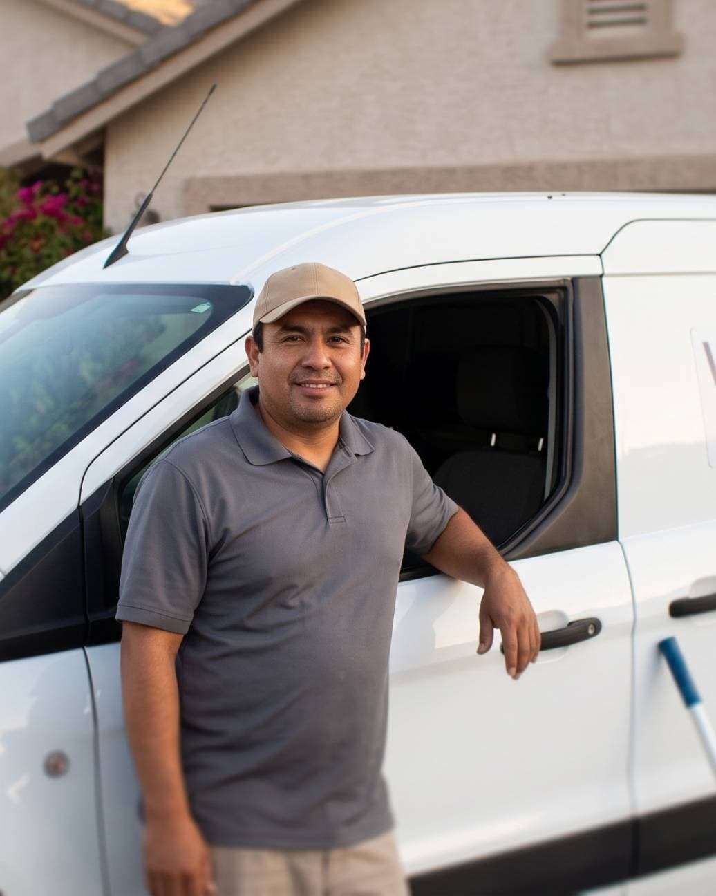 A pool service operator standing by a backyard pool